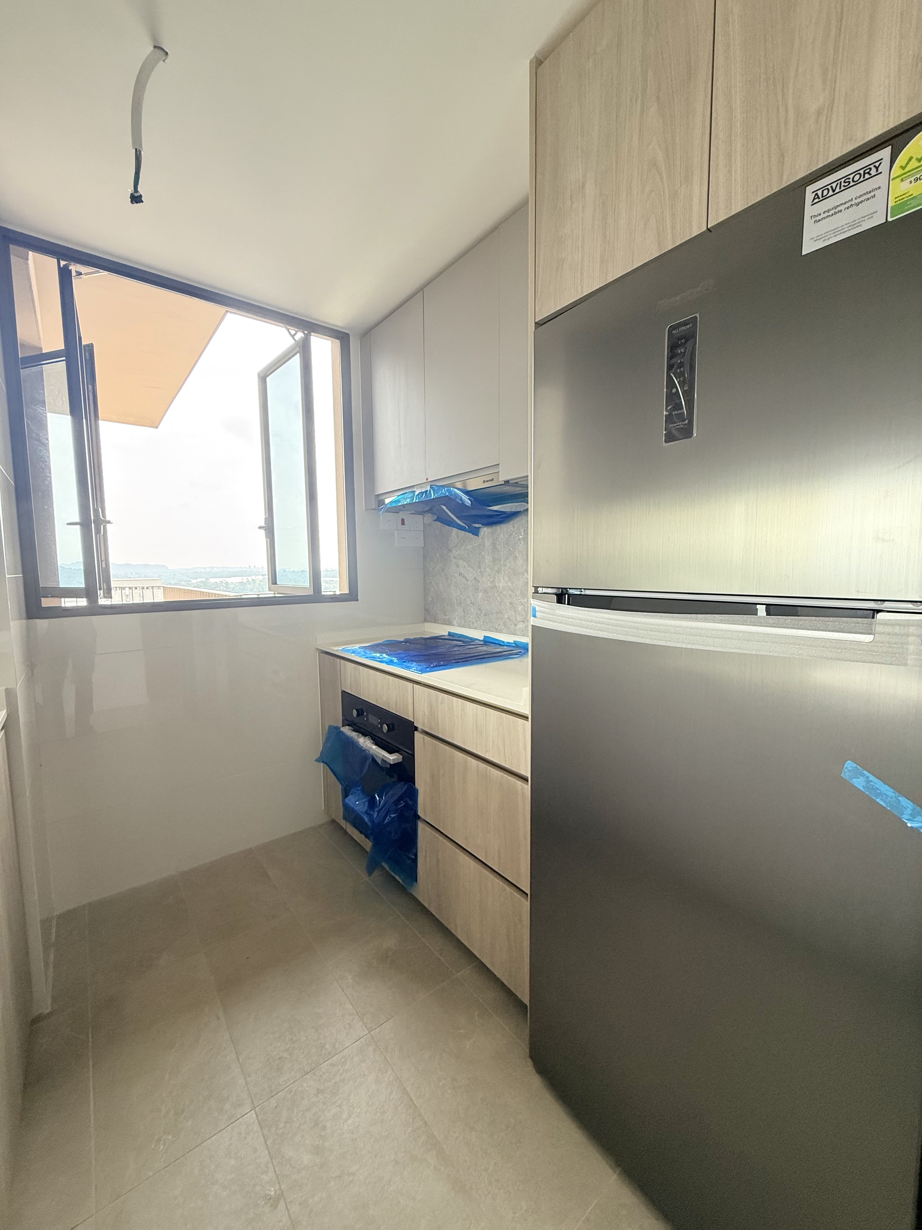 Enclosed kitchen at AMO Residence with new fridge and appliances
