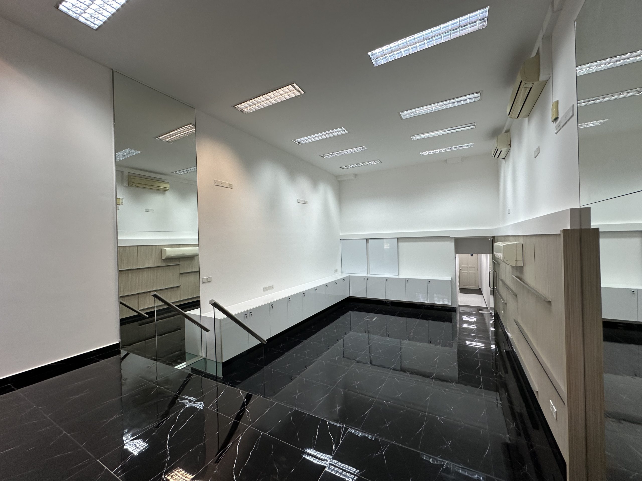 Glossy black flooring and high ceiling inside Cantonment Road shophouse