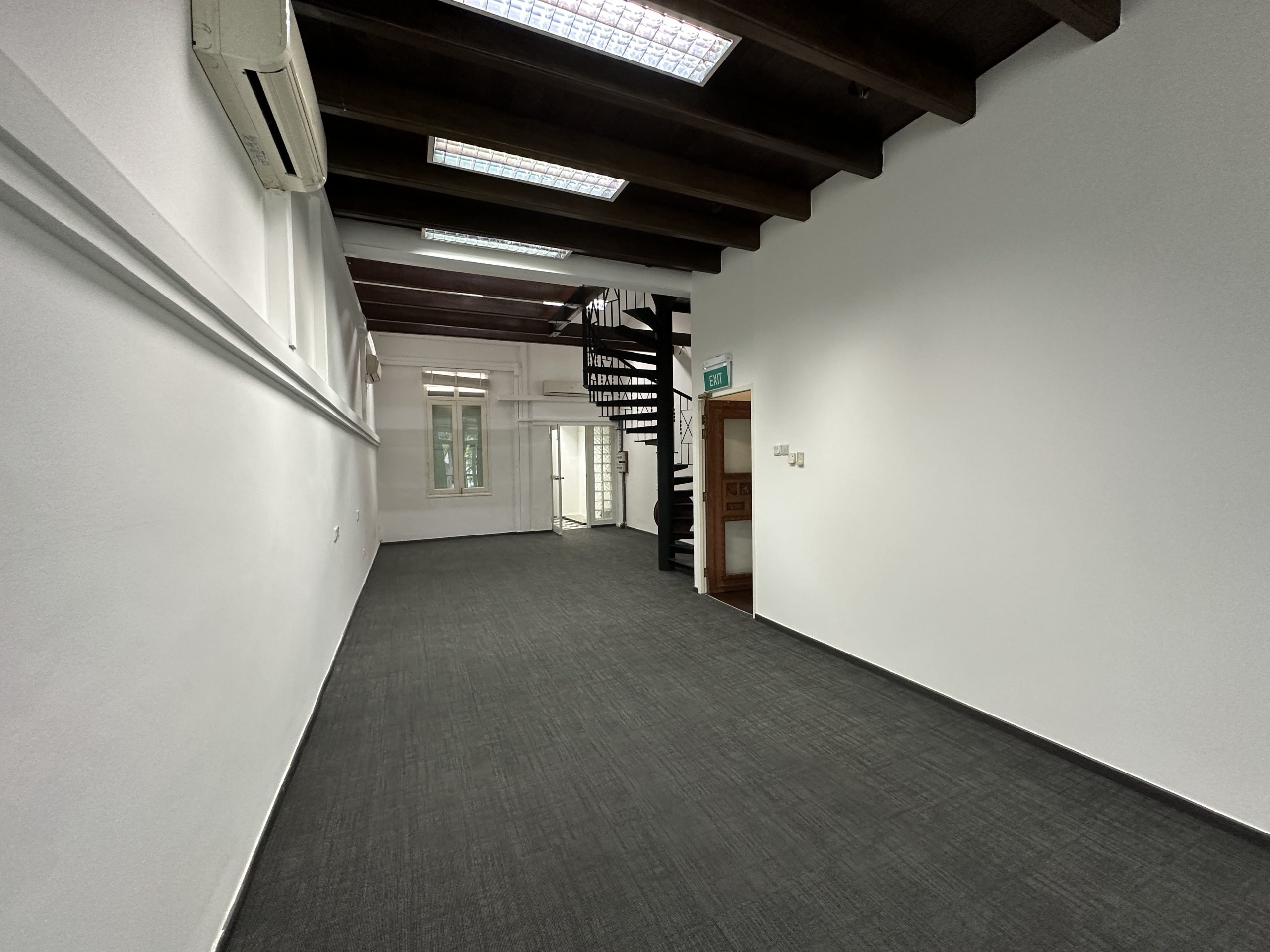 Heritage beams and spiral staircase inside Cantonment Road conservation shophouse
